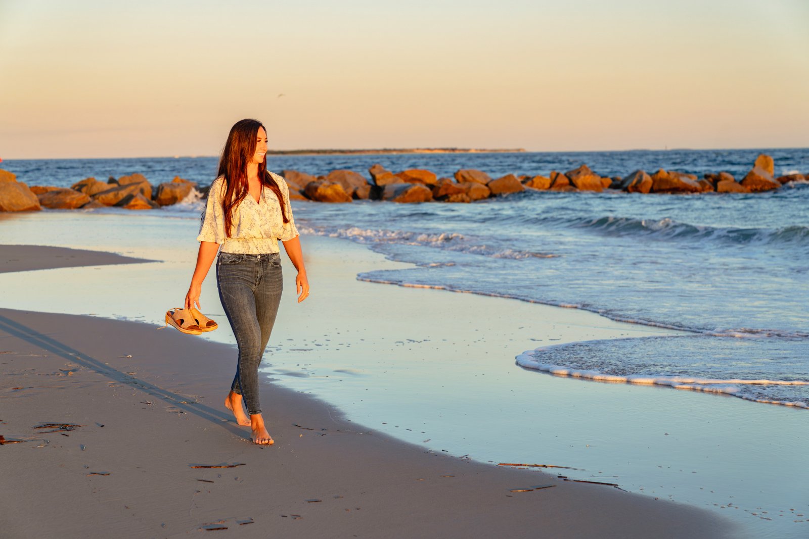 Sally Herman walking on the beach at sunset